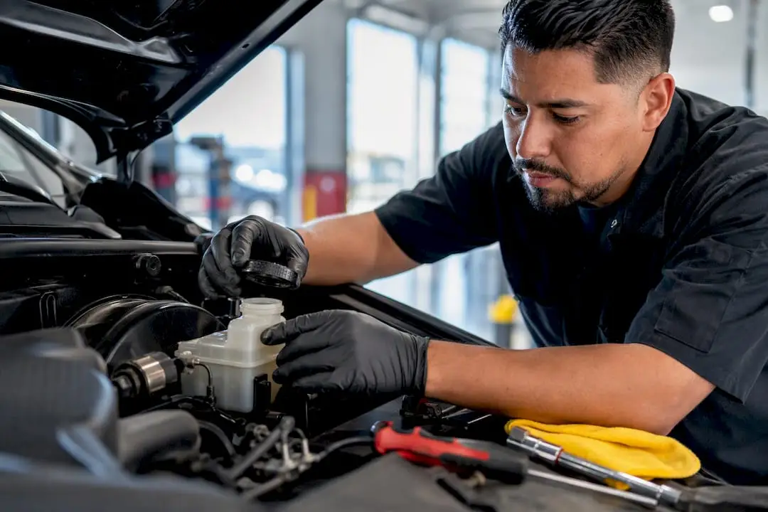 Technician checking brake fluid reservoir