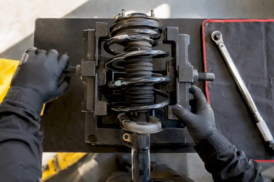 Technician securing coil spring compressor